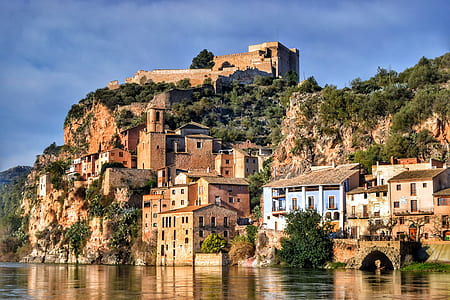 brown houses beside body of water at daytime thumbnail