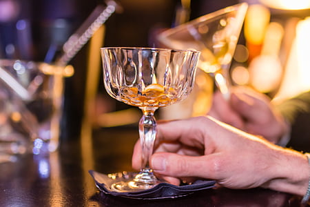 person holding long-stem wine glass thumbnail