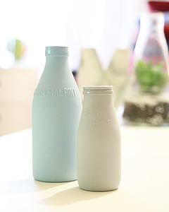selective focus photography of two white and blue milk bottles thumbnail