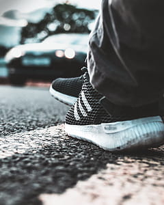 Person Wearing White-and-black Adidas Running Shoes thumbnail