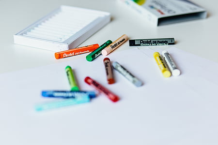 assorted-color Pentel crayons on white surface thumbnail