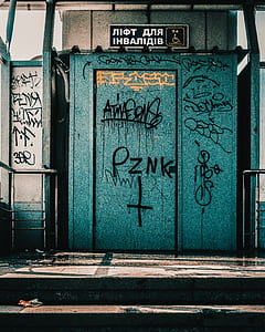 teal and black wooden door thumbnail