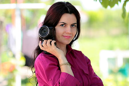 woman holding DSLR camera thumbnail
