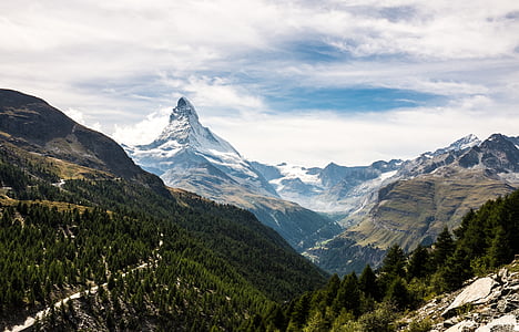 snow covered mountains under cloudy sky thumbnail