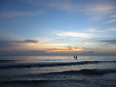 two people on body of water under blue sky during daytime thumbnail