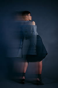 Woman Wearing Blue Long-sleeved Top and Black Skirt thumbnail