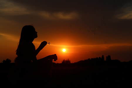 silhouette photo of a woman holding bubble making stick thumbnail