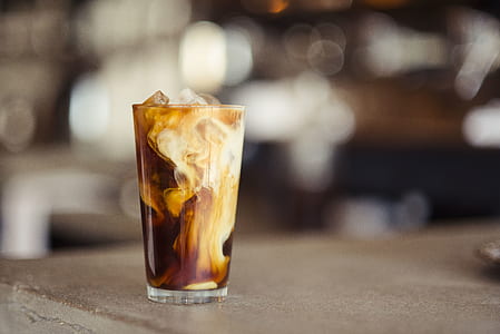 tilt shift photography of glass of iced coffee thumbnail