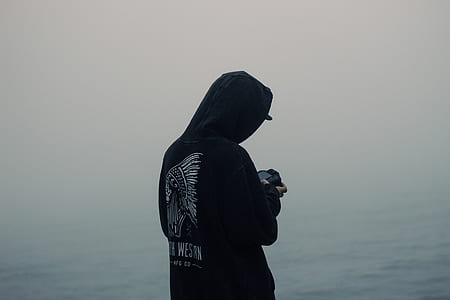 man standing beside body of water looking down to the camera thumbnail