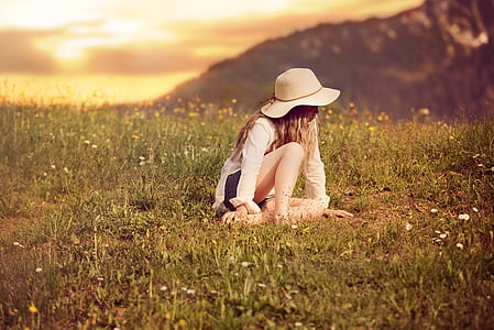 woman sitting on green grass field thumbnail