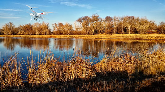 white and red DJI Phantom 2 near body of water during daytime thumbnail