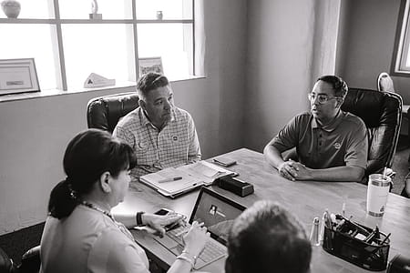 Grayscale Photo of People Inside A Room Having A Meeting thumbnail