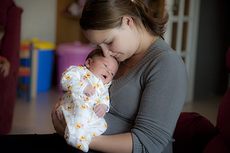 woman carrying baby thumbnail
