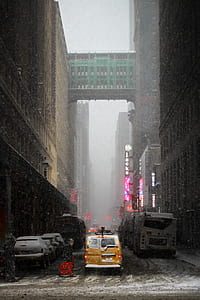 brown van in between high-rise building towards green bridge thumbnail