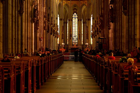 people sitting on brown pewters inside chapel thumbnail