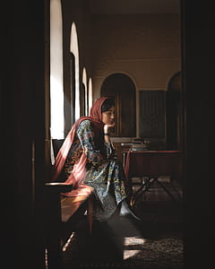side view of woman sitting on bench thumbnail