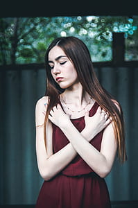 long blonde-haired woman in red sleeveless dress thumbnail