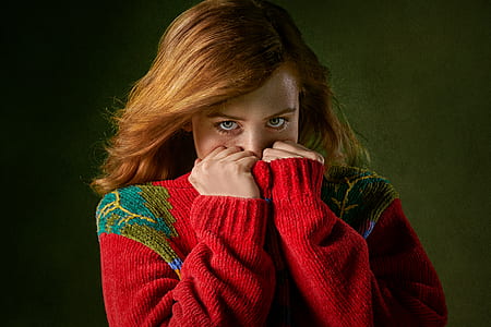 photo of woman wearing red sweater covering face thumbnail