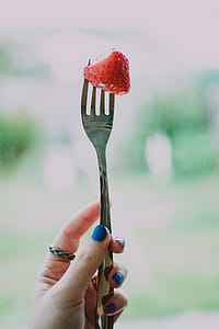 Person Holding Gray Steel Fork With Strawberry thumbnail