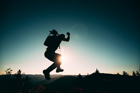 silhouette of man jumps on top of mountain thumbnail