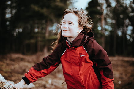boy standing near trees thumbnail