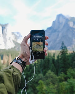 person taking photo of mountain range thumbnail