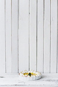 Round White Bowl of Foods on White Wooden Panel thumbnail