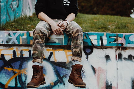 man sitting on street art wall thumbnail