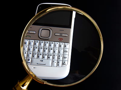 white QWERTY phone on black surface thumbnail