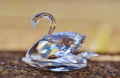 shallow focus photo of cut-glass swan paperweights thumbnail