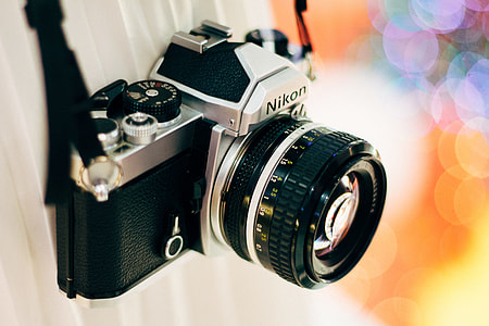 bokeh photography of gray Nikon film camera thumbnail