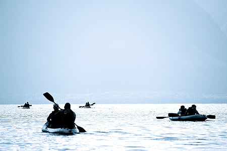 four people riding boat paddling on sea during daytime thumbnail
