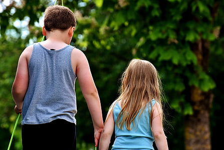 two child holding hands near on tree thumbnail