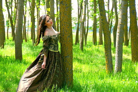 woman wearing brown floral dress standing beside tree thumbnail