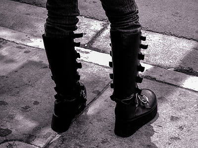 grayscale photo of person wearing boots thumbnail