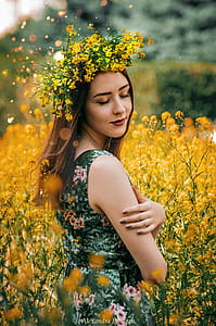 Woman Wearing Green and Pink Floral Sleeveless Dress With Yellow Flower Headdress thumbnail
