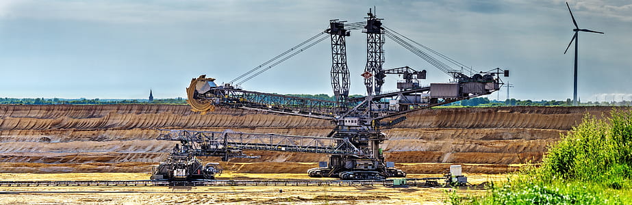 black heavy equipment near windmill thumbnail