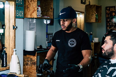 Man Wearing Black Shirt Standing Near Man Wearing Gray Shirt Inside Room thumbnail