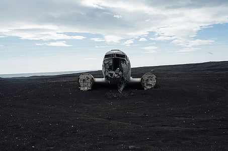 white plane wreckage on land thumbnail