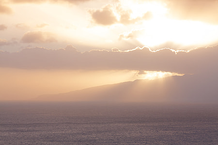 body of water under the cloudy sky during sunshine thumbnail