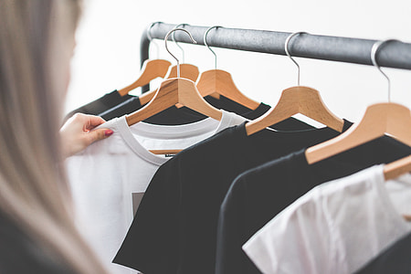 Woman Choosing T-Shirts During Clothing Shopping at Apparel Store thumbnail