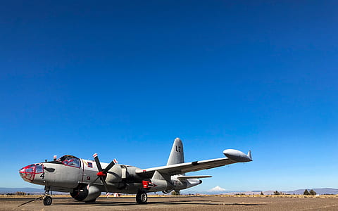 gray airplane under blue sky thumbnail