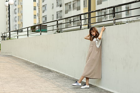 woman standing on road holding wall thumbnail
