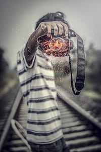 grayscale photography of man holding camera thumbnail