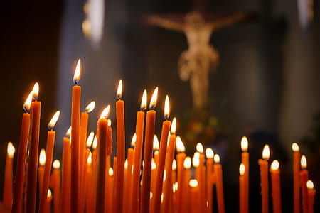 lighted candle near crucifix photo thumbnail