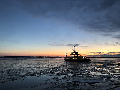 ship on body of water under gray sky thumbnail