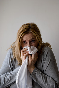 woman sneezing on white textile thumbnail
