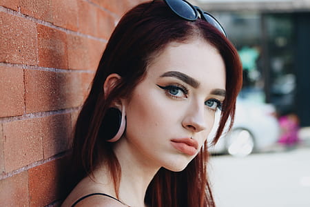 woman leaning on brick wall thumbnail