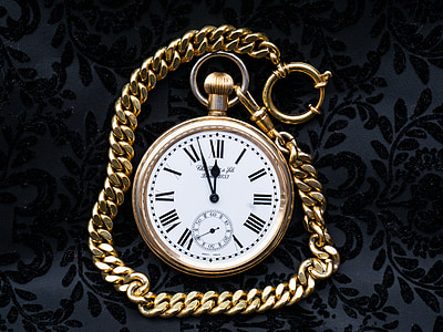 white pocket watch with gold-colored chain thumbnail