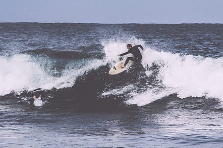 man surfboarding on ocean wave thumbnail